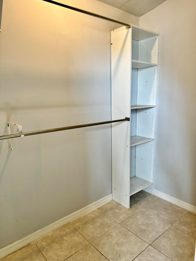 spacious closet with light tile patterned floors