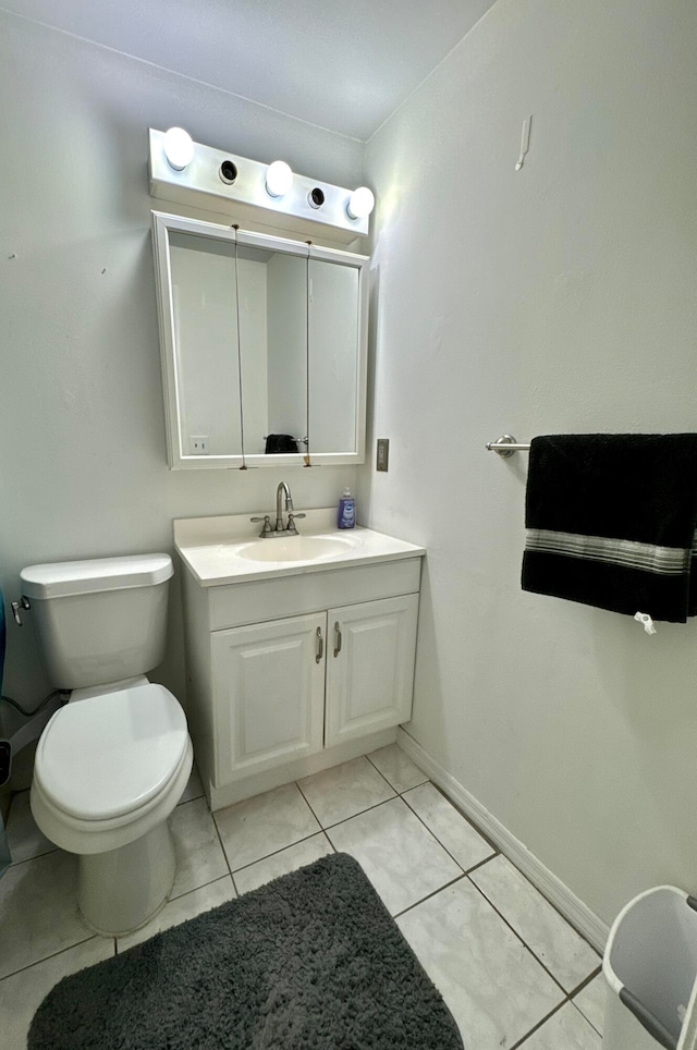 bathroom featuring vanity, toilet, and tile patterned floors