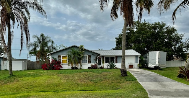 single story home with a front lawn and a garage