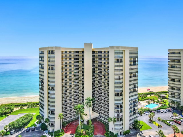 view of building exterior featuring a view of the beach and a water view