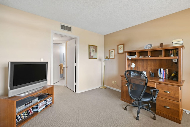 carpeted office space with a textured ceiling