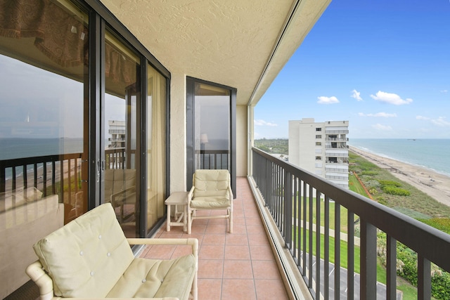 balcony with a beach view and a water view