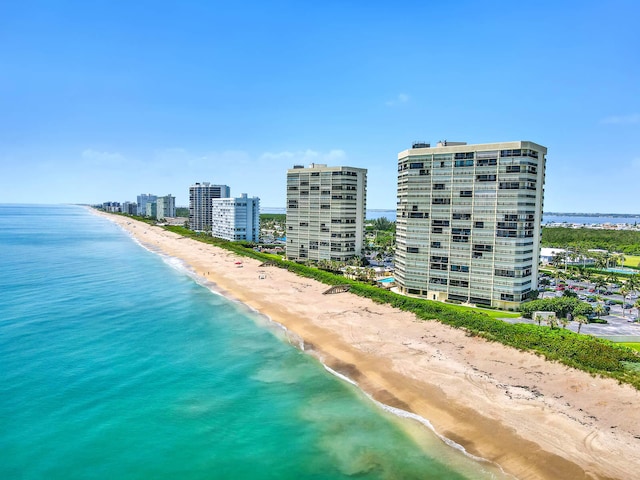 drone / aerial view featuring a water view and a view of the beach