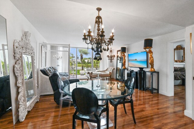 dining room with a chandelier and dark hardwood / wood-style floors