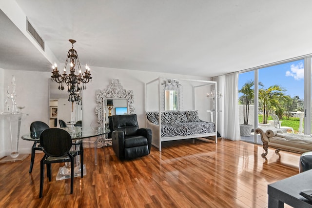 living room featuring wood-type flooring and a notable chandelier