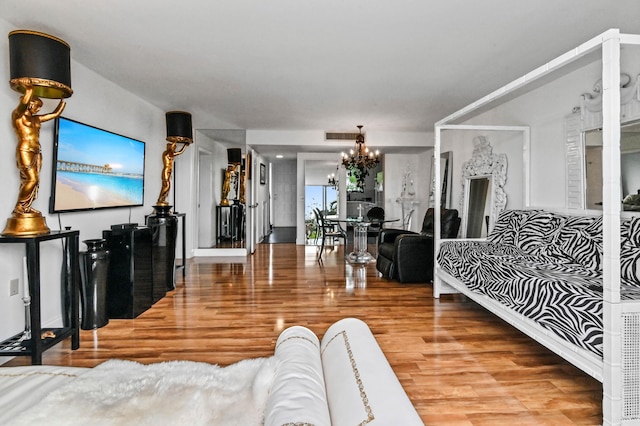 living room with a notable chandelier and hardwood / wood-style floors