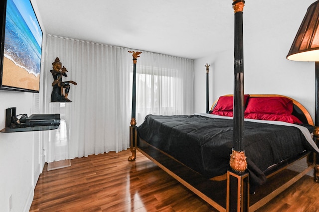 bedroom with dark wood-type flooring