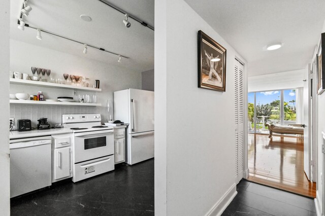 kitchen with open shelves, light countertops, backsplash, white appliances, and baseboards