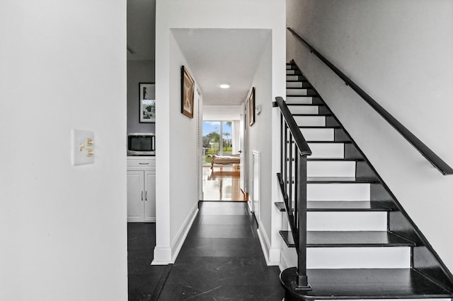 stairs with dark tile patterned floors