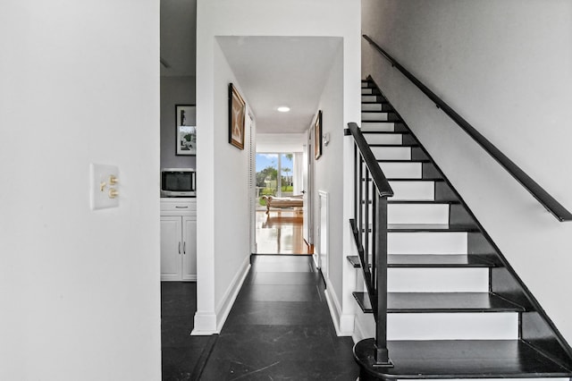 stairs featuring baseboards