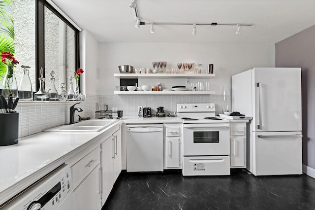 kitchen with sink, white appliances, a wealth of natural light, and white cabinets