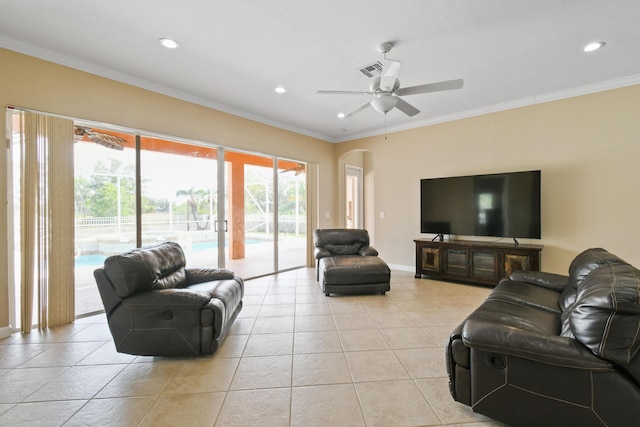 living area with arched walkways, crown molding, recessed lighting, visible vents, and light tile patterned flooring