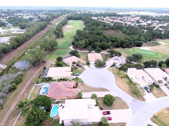 drone / aerial view featuring view of golf course and a residential view