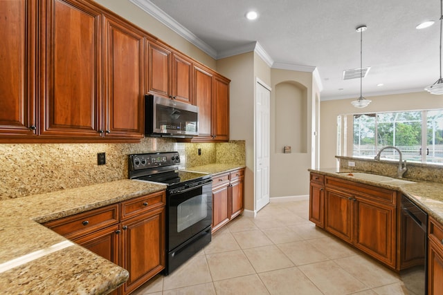 kitchen with light stone counters, pendant lighting, visible vents, a sink, and black appliances