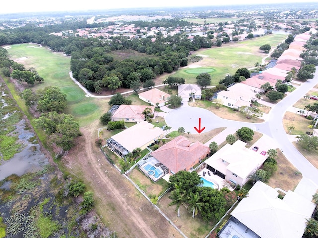 drone / aerial view with a residential view and golf course view