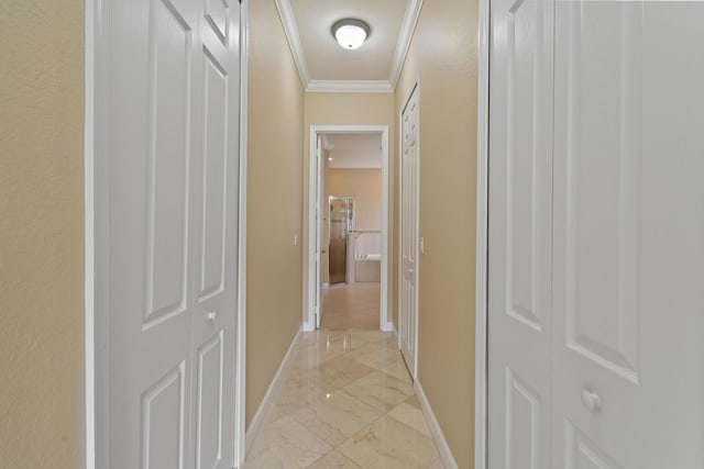 hall with marble finish floor, baseboards, and crown molding