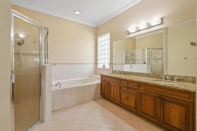 full bath with a bath, tile patterned flooring, ornamental molding, and a sink