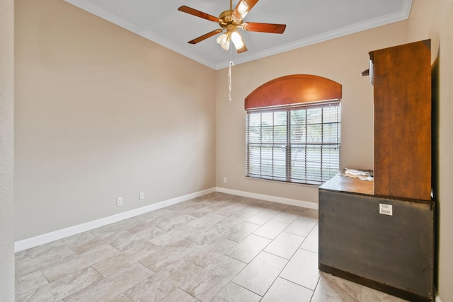 empty room featuring ceiling fan, ornamental molding, and baseboards