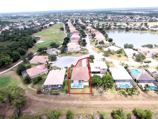 bird's eye view with a residential view, a water view, and golf course view