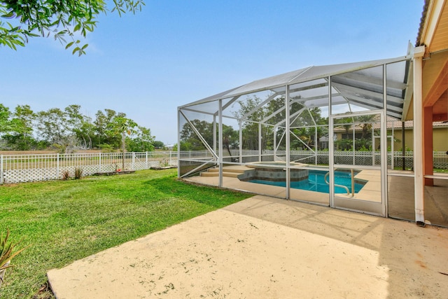 view of swimming pool featuring glass enclosure, fence private yard, a yard, a patio area, and a pool with connected hot tub