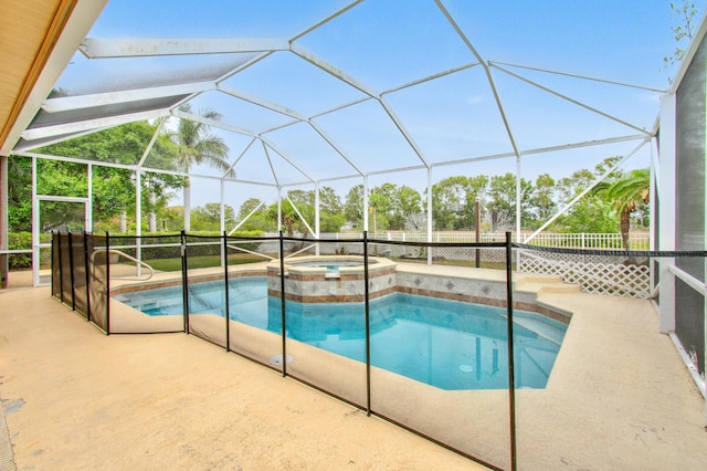 view of pool featuring a patio area, glass enclosure, and a pool with connected hot tub