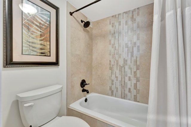 bathroom featuring shower / bath combination with curtain and toilet