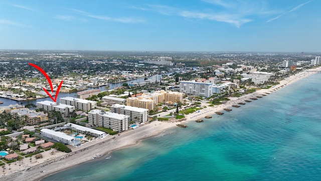 drone / aerial view with a water view and a view of the beach