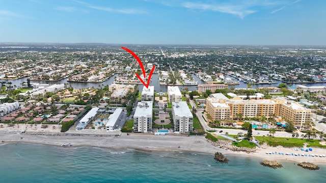 birds eye view of property with a water view and a view of the beach