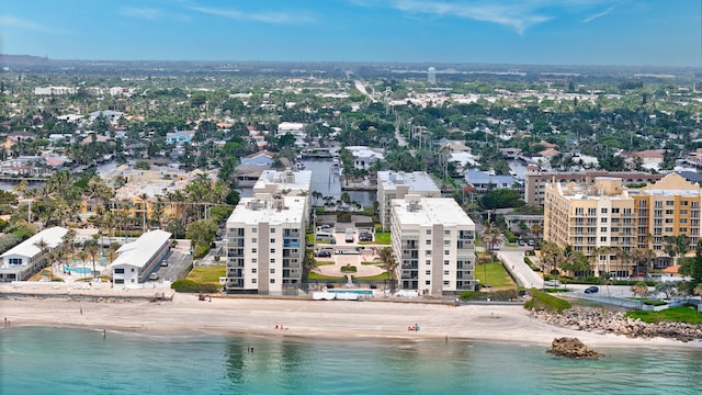 bird's eye view with a water view and a beach view