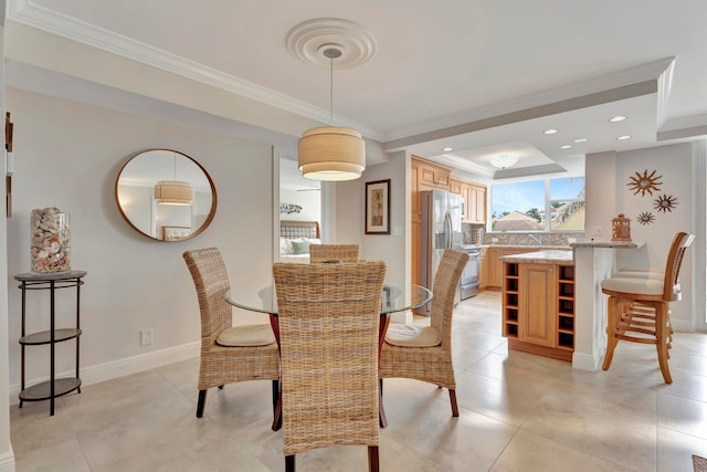 tiled dining space featuring ornamental molding