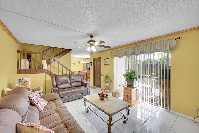 living room featuring light tile patterned floors, stairway, and a textured ceiling