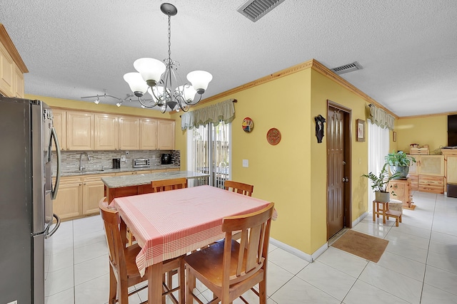 dining room with light tile patterned floors, crown molding, visible vents, and an inviting chandelier