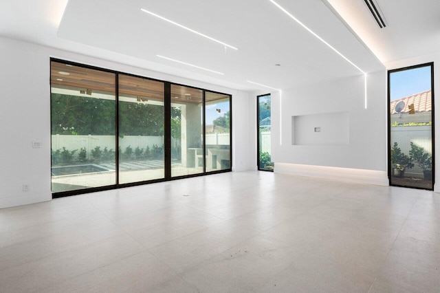 spare room featuring a wealth of natural light and expansive windows