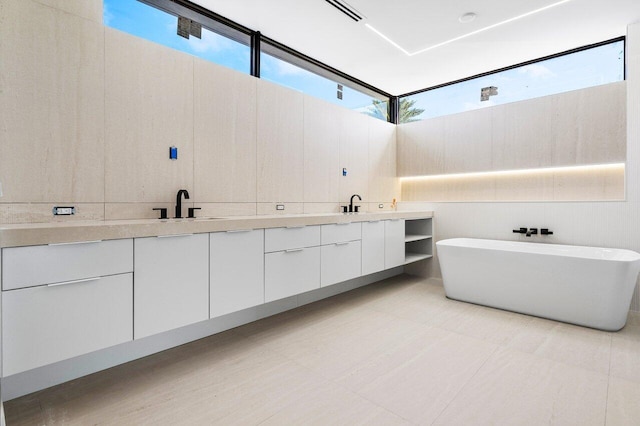 bathroom featuring vanity and a tub to relax in