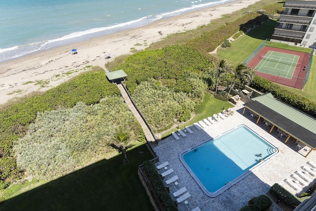 birds eye view of property with a water view and a view of the beach