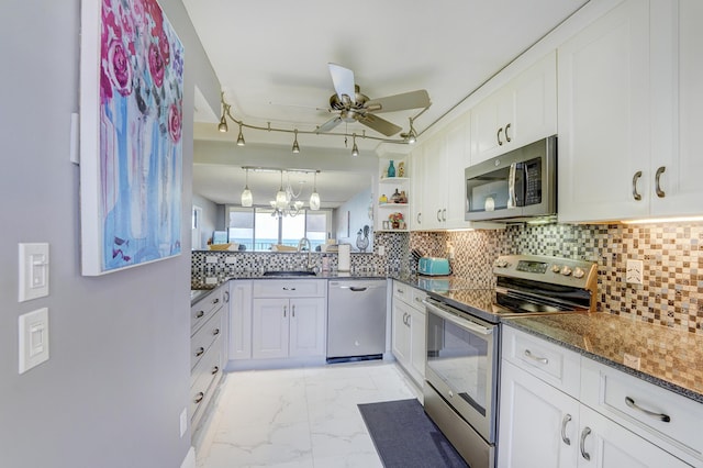 kitchen with appliances with stainless steel finishes, white cabinetry, and ceiling fan