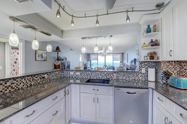 kitchen with dishwasher, white cabinetry, sink, and dark stone counters