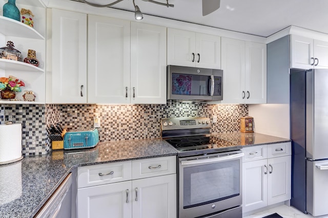 kitchen with white cabinetry, stainless steel appliances, and tasteful backsplash