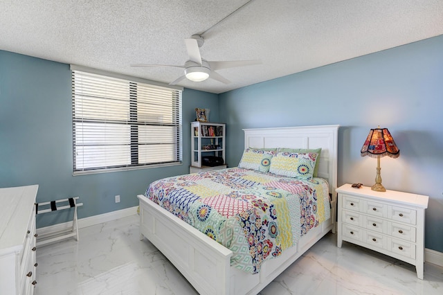 bedroom featuring ceiling fan and a textured ceiling