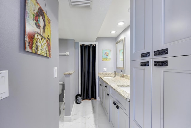 bathroom with vanity and toilet