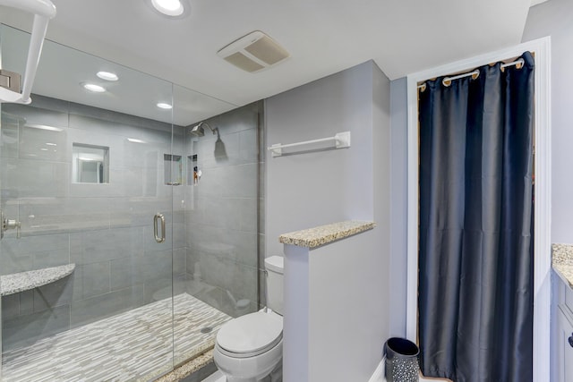 bathroom with vanity, toilet, and a shower with shower door