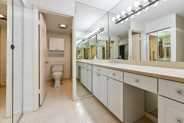 bathroom with vanity, toilet, and tile patterned floors