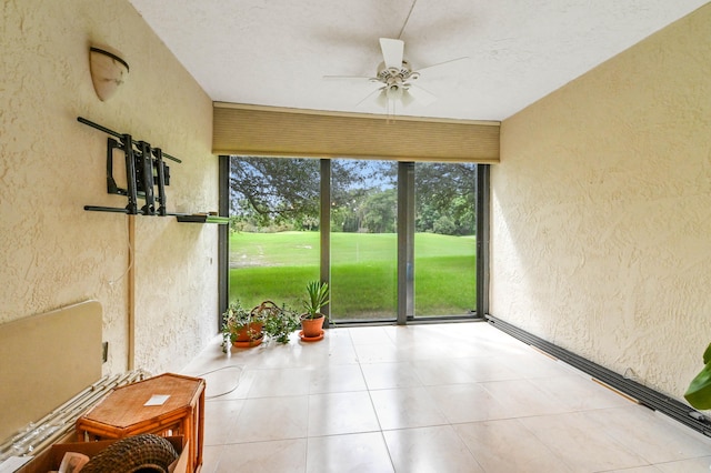 sunroom featuring ceiling fan