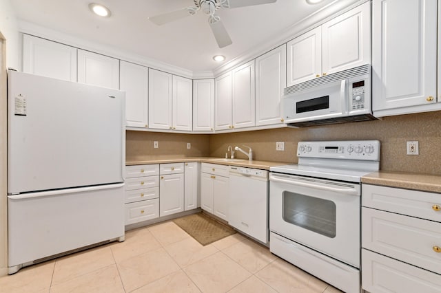 kitchen featuring white appliances, sink, ceiling fan, white cabinets, and light tile patterned floors