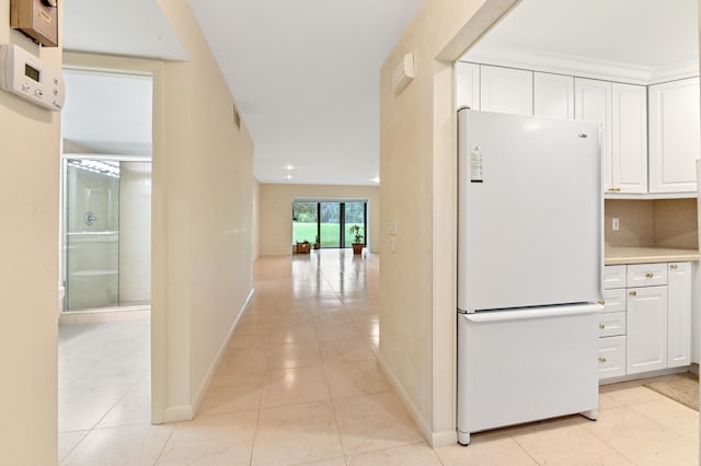 hall featuring light tile patterned flooring