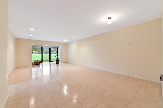 spare room featuring light tile patterned flooring