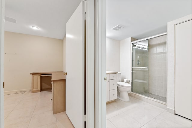 bathroom featuring vanity, a shower with shower door, toilet, and tile patterned floors