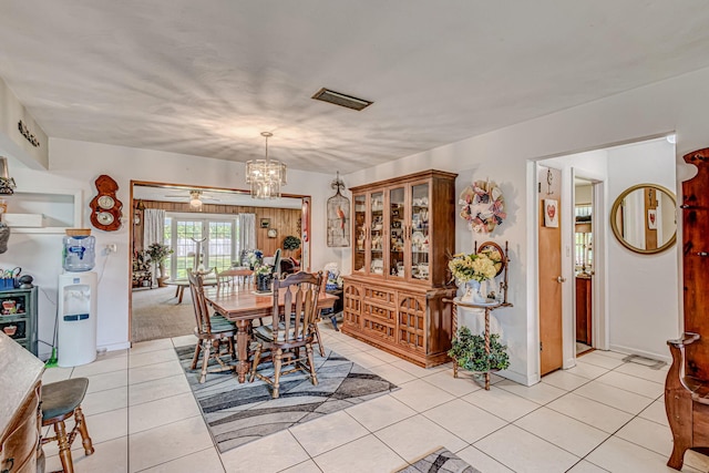 dining room featuring ceiling fan with notable chandelier and light tile flooring