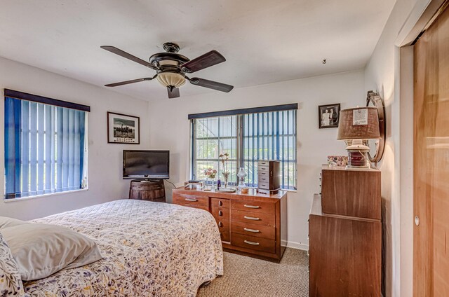 carpeted bedroom with ceiling fan