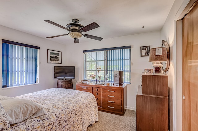 bedroom featuring ceiling fan and light colored carpet